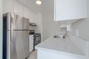 San Diego apartment for rent - a kitchen with white counter tops and a stainless steel refrigerator at Citra Apartments LLC, San Diego