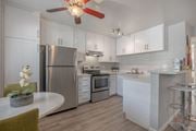 Napa apartment for rent - a kitchen with blue and red lights on the ceiling and white counters at Napa Green Apartments LLC, California, 94559