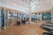 Napa apartment for rent - a gym with cardio machines and weights on a wooden floor at Napa Green Apartments LLC, Napa, CA 94559