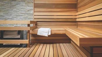 A sauna with wooden steps and a white towel