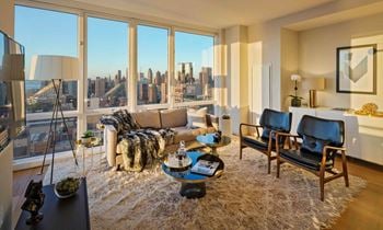 The living room of an apartment with a view of the city