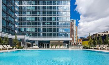 A swimming pool in front of a tall building