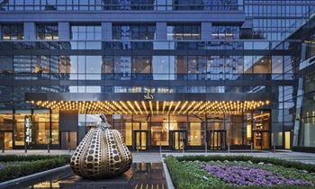 A large building with a sculpture in front of it