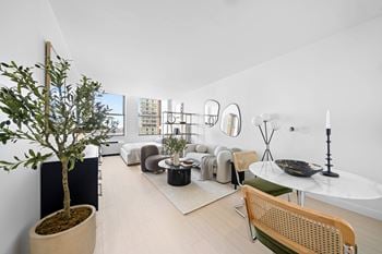A living room with a tree at one west,new york, ny