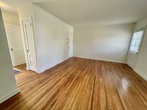 Birmingham apartment for rent - an empty living room with wood floors and white walls