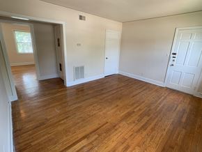 Birmingham apartment for rent - an empty living room with wooden floors and white walls