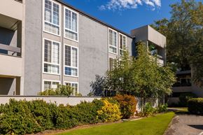 Concord apartment for rent - A modern building with a well-maintained lawn in front.
