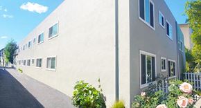 Alameda apartment for rent - a large white building with flowers in front of it
