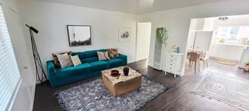Alameda apartment for rent - A living room with a blue couch and a wooden coffee table.