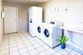 Concord apartment for rent - A laundry room with a white tiled floor and a white door.