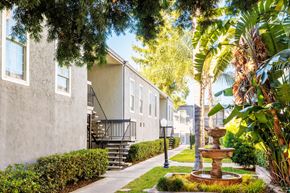 Concord apartment for rent - A fountain in the middle of a grassy area in front of a building.