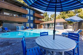 Concord apartment for rent - A blue and white pool area with a table and chairs.