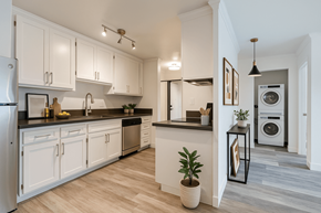 Hayward apartment for rent - A modern kitchen with white cabinets and a wooden floor.