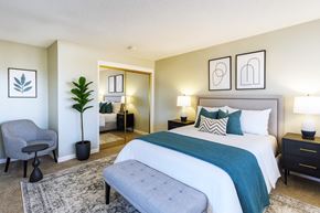 San Lorenzo apartment for rent - A bedroom with a large bed and a grey chair.