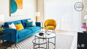 San Leandro apartment for rent - A living room with a blue couch, a yellow chair, and a coffee table.