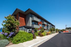 Belmont apartment for rent - a modern apartment building with a street in front of it