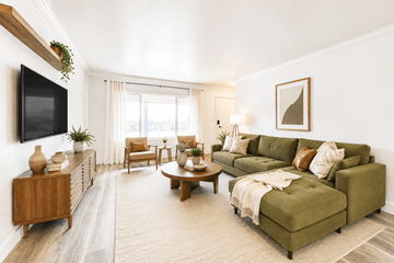 Hayward apartment for rent - A living room with a green couch and a wooden cabinet.