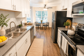 Fremont apartment for rent - A kitchen with a black refrigerator and stove top oven.