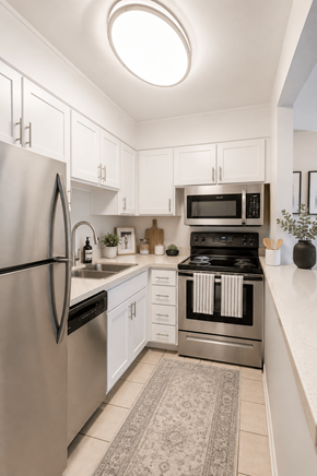 Livermore apartment for rent - A modern kitchen with a refrigerator, microwave, and oven.