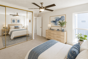 Concord apartment for rent - A bedroom with a large bed and a ceiling fan.