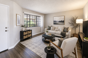 San Lorenzo apartment for rent - A living room with a white couch, a black coffee table, and a white chair.
