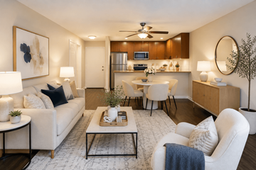 Concord apartment for rent - A modern living room with a white sofa, a coffee table, and a ceiling fan.