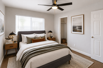 Hayward apartment for rent - A bedroom with a large bed and a ceiling fan.