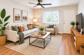 Concord apartment for rent - A living room with a white couch, a coffee table, and a ceiling fan.