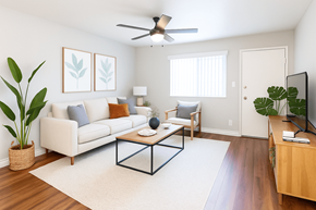 Concord apartment for rent - A living room with a white couch, a coffee table, and a ceiling fan.