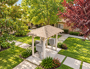 Concord apartment for rent - A gazebo is surrounded by a garden with a house in the background.