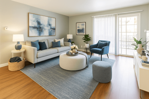 Hayward apartment for rent - A living room with a white couch, a blue chair, and a grey ottoman.