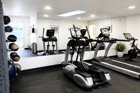 San Leandro apartment for rent - A gym with a treadmill, exercise bike, and weights.