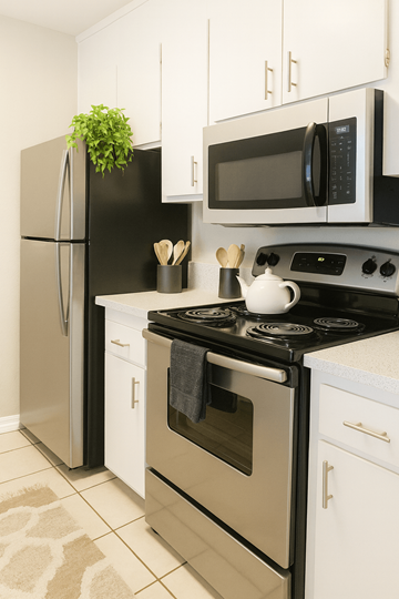 Concord apartment for rent - A black fridge and microwave in a white kitchen.