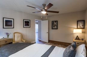 Concord apartment for rent - a bedroom with a large bed and a ceiling fan
