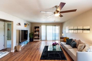 Concord apartment for rent - A living room with a white couch and a ceiling fan.