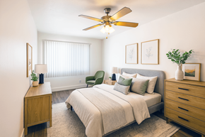 San Leandro apartment for rent - A bedroom with a bed, nightstand, and chair.