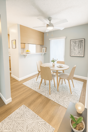 Concord apartment for rent - A dining room with a table set for two and a ceiling fan.