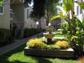 Concord apartment for rent - a fountain in a garden in front of an apartment building