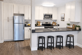Fremont apartment for rent - A kitchen with white cabinets and a stainless steel refrigerator.
