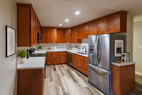 San Leandro apartment for rent - A modern kitchen with wooden cabinets and a stainless steel refrigerator.