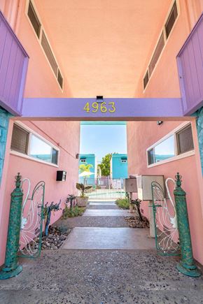 San Jose apartment for rent - A pink building with a number 4963 on the top.
