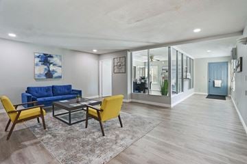 Fairfield apartment for rent - A living room with a blue couch and yellow chairs.