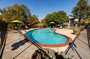 Livermore apartment for rent - A small pool surrounded by a deck and trees.
