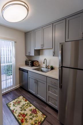 Concord apartment for rent - A kitchen with a refrigerator, sink, and cabinets.