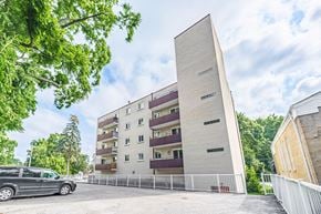 Whitby apartment for rent - A modern building with a white facade and a tall rectangular section on the right side.