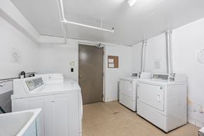 Whitby apartment for rent - A room with two washing machines and a door.