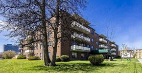 North York apartment for rent - A large apartment building with a green awning on the second floor.