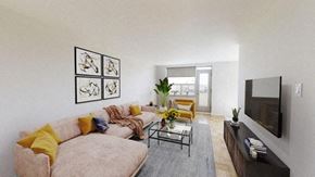 North York apartment for rent - A living room with a couch, a coffee table, and a television.