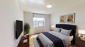 North York apartment for rent - A bedroom with a large bed and a flat screen TV mounted on the wall.