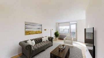 North York apartment for rent - A living room with a grey couch and a painting on the wall.